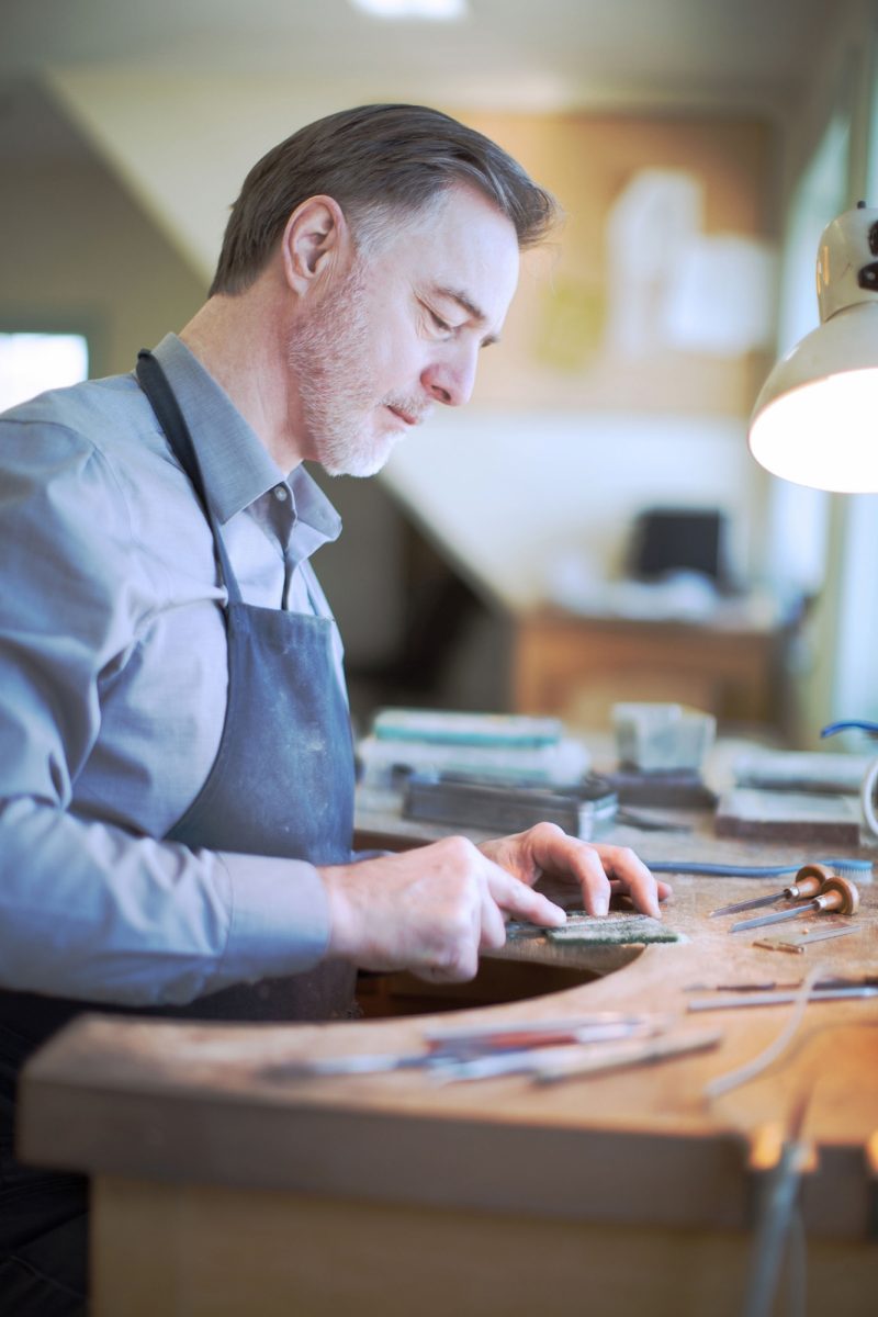 Person crafting pewter at Amos Pewter