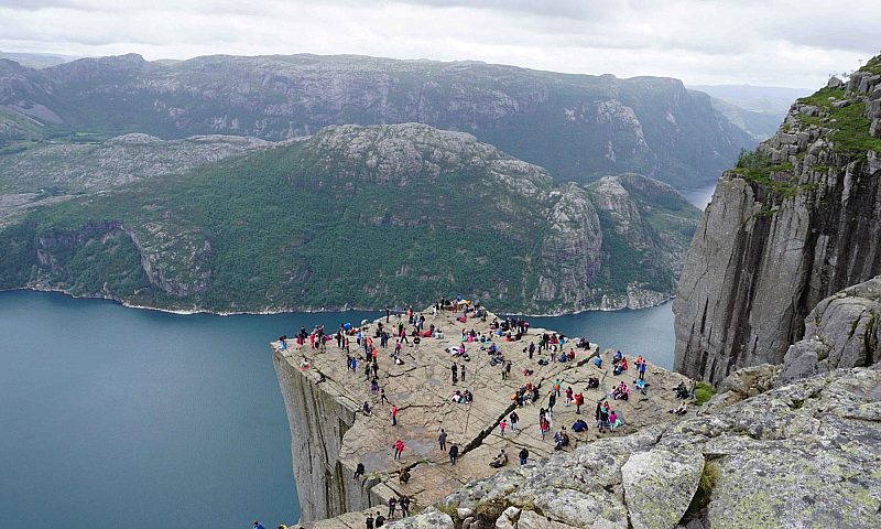 People at the top of the Pulpit Rock hike in Norway