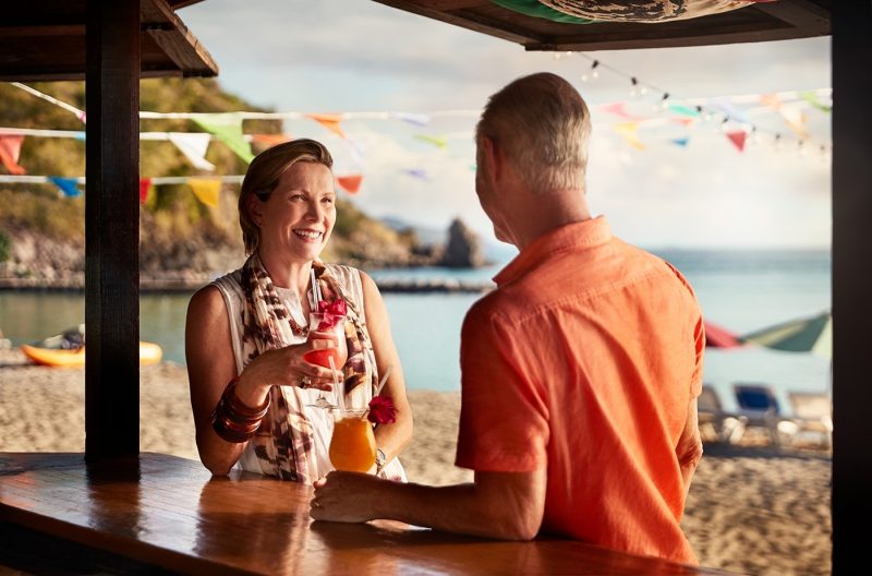 Couple enjoying drinks on St Kitts beach