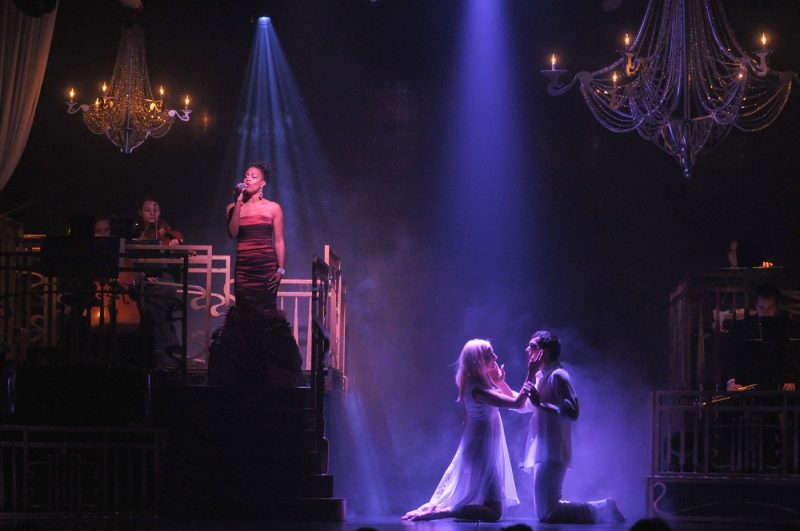 Performers on stage singing and dancing at the Bravo Theater Show onboard Princess Cruises