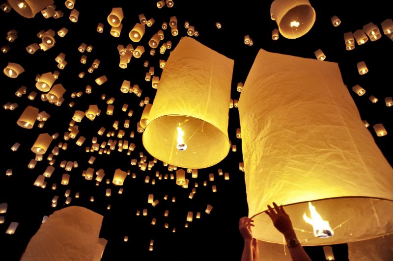 Traditional fire lanterns being released into the night sky