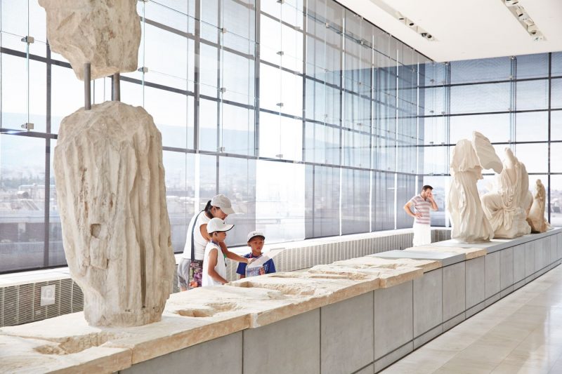 A family enjoying a visit to the Acropolis Museum in Athens