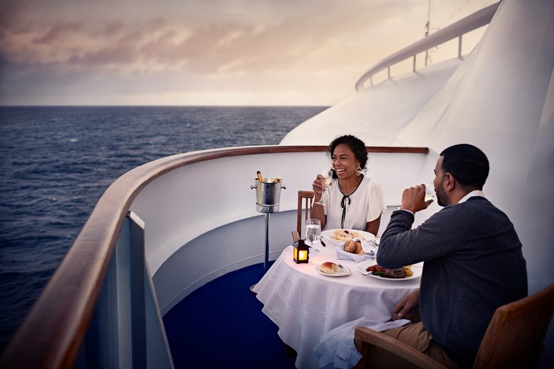 Two people dining at dusk on ship