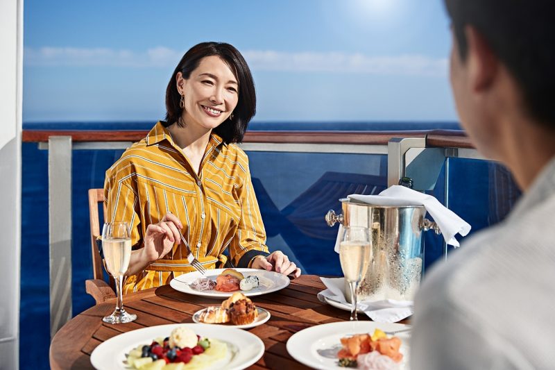 A couple eating food on balcony