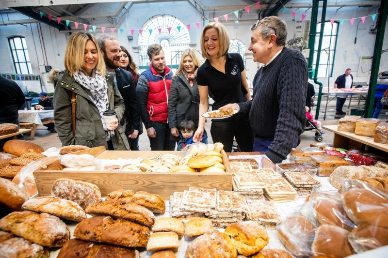 Image of visitors bread sampling at St George's Market with tour guide