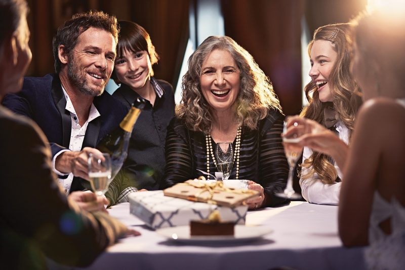 A woman and friends celebrating with cake