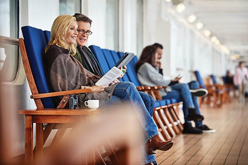 A couple relaxing with a book onboard Princess