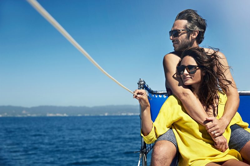 Couple wearing sunglasses on boat