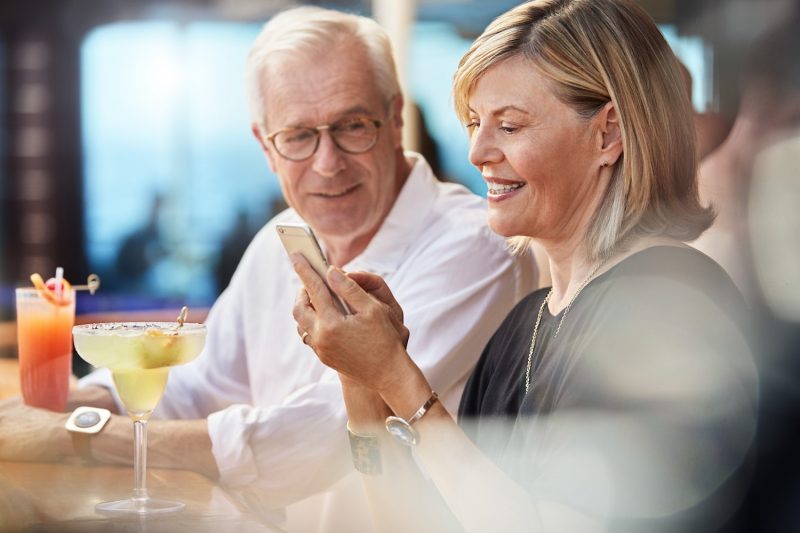 Couple with phone and drinks