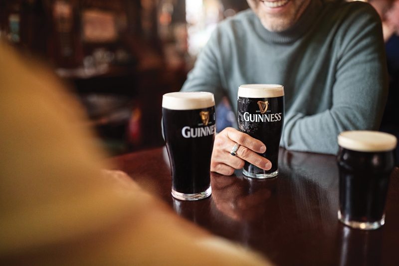 Friends enjoying pints of Guinness