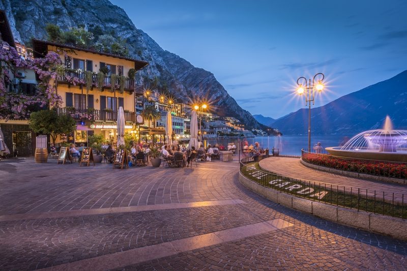 View of illuminated promenade at the port of Limone at dusk