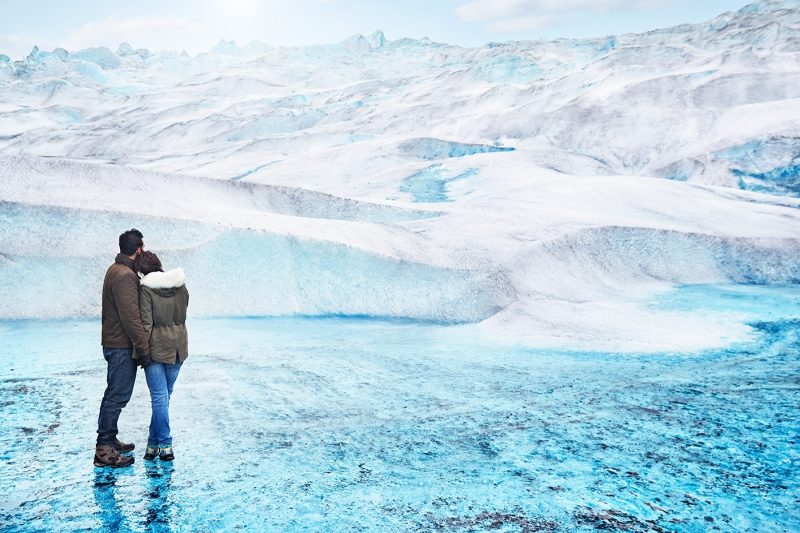 Two people standing on Medenhall Glacier, Alaska