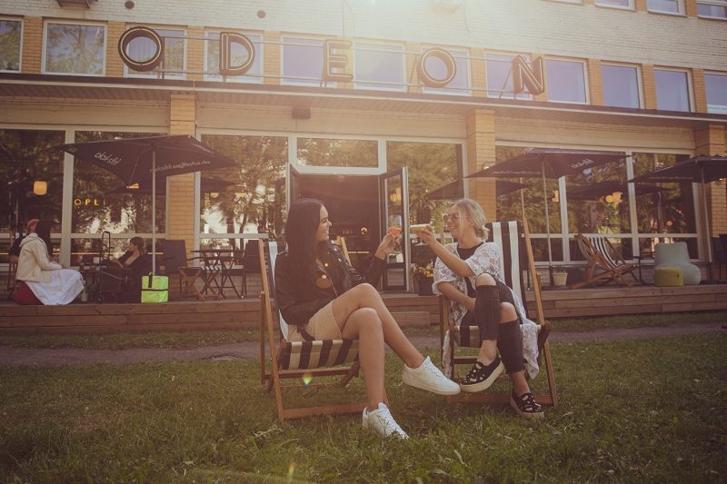 Two girls enjoying cocktails outside