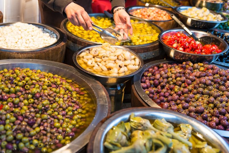 Someone serving olives from a stall in Catania Italy