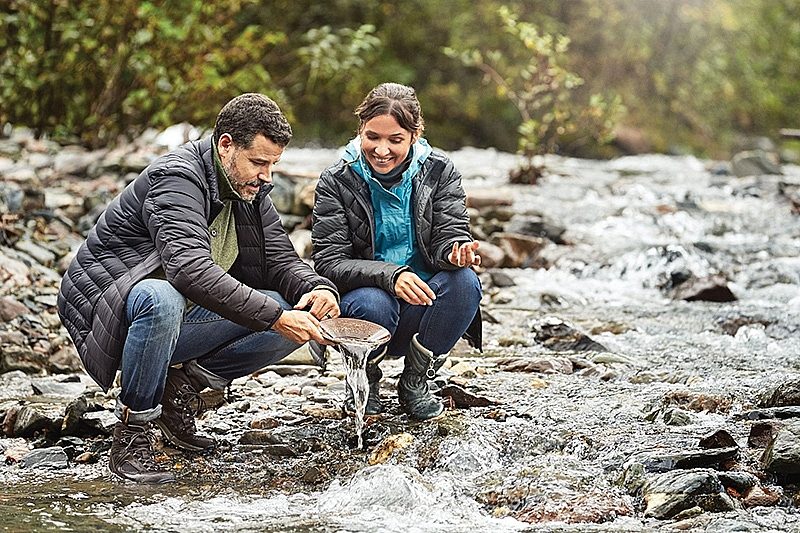 A couple panning for gold in Alaska