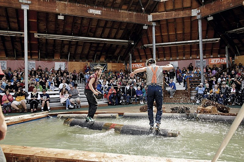 Two men taking part in log rolling in an Alaskan lumberjack show with Princess Cruises