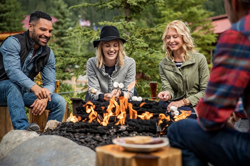 Four people around campfire in Alaska