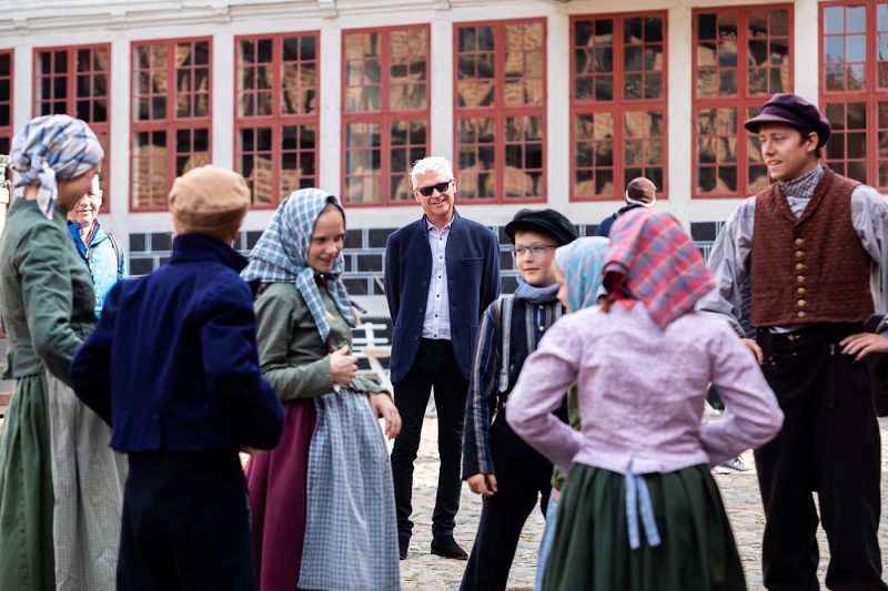 Phillip with staff in period costumes at Den Gamle By open-air museum