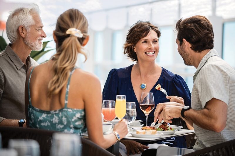 Four friends eating food onboard ship