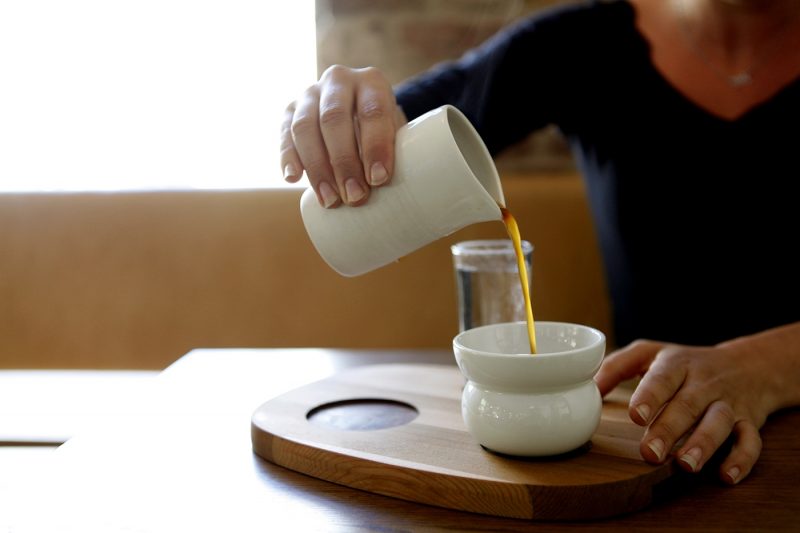 Person pouring cup of coffee at Tim Wendelboe