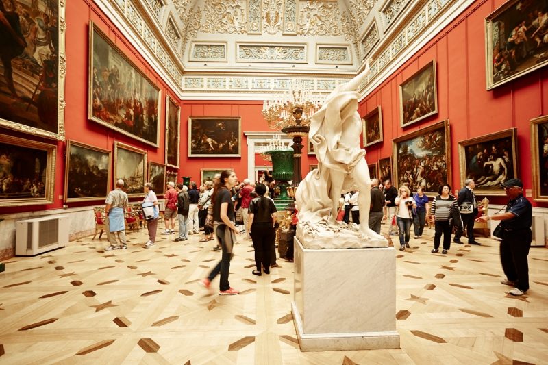 People walking around looking at exhibits at The Hermitage Museum in St Petersburg Russia