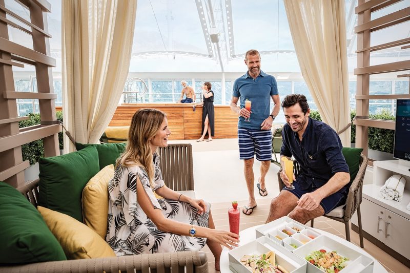 Three friends relaxing on chairs on cruise ship