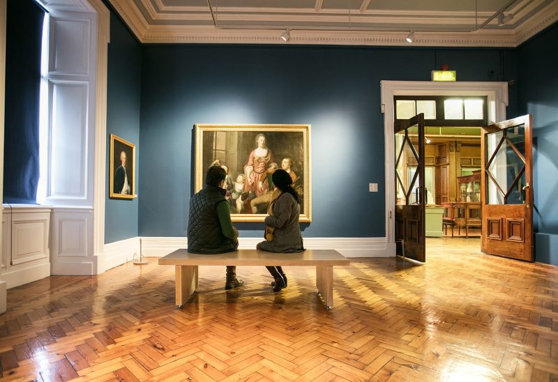 Two people looking at artwork in Crawford Art Gallery
