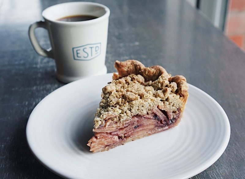 Coffee cup and slice of fruit pie