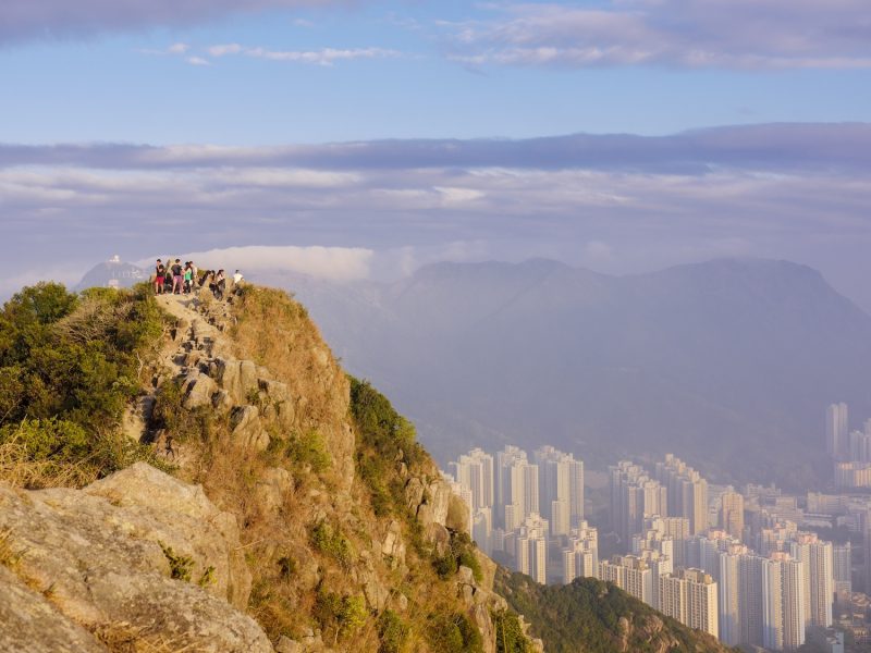 Hikers at the Lion Rock mountain peak, viewing the city of Hong Kong from a high point