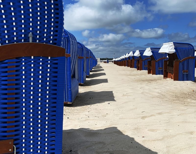 Blue chairs on sand in Warnermude