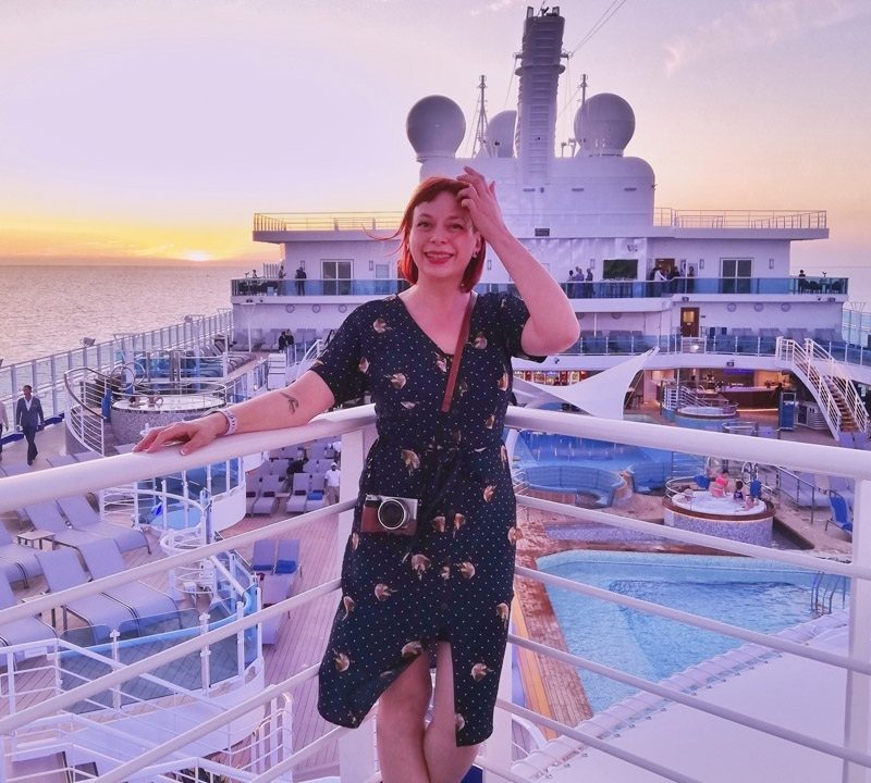 Blogger Alice Teacake on the main deck of Sky Princess at sunset