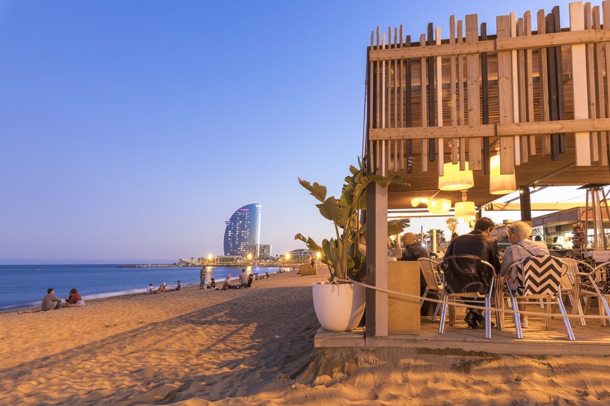 People eating at beachside restaurant in Barcelona