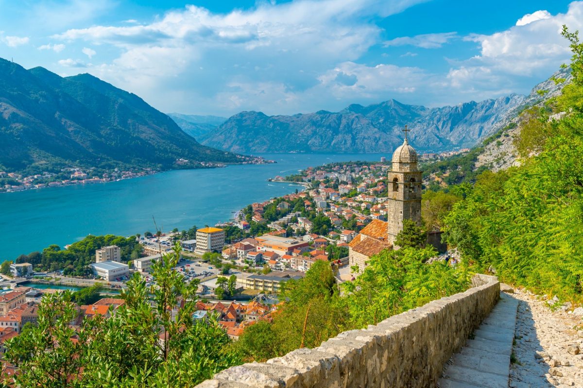 View over water and Chapel of Our Lady of Salvation overlooking the Old Town, UNESCO World Heritage Site, Kotor, Montenegro