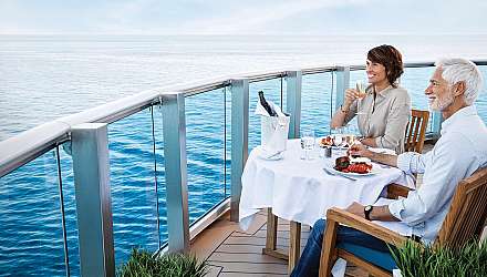Two people eating on balcony of cruise ship