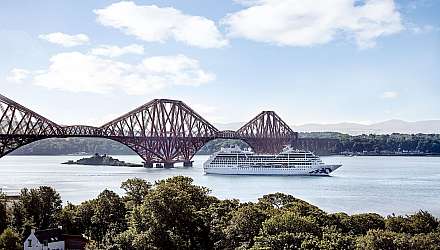 Pacific Princess sailing under the Forth Bridge in Scotland