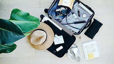 Open suitcase with holiday items